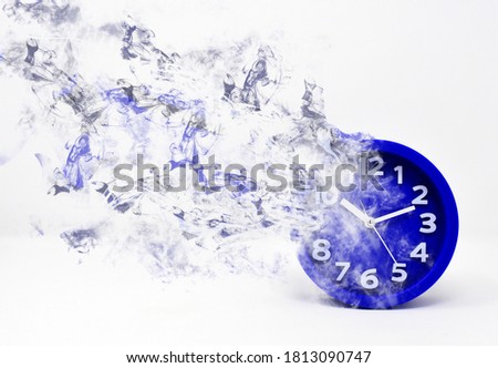 
The clock turns and vanishes in smoke. Concept of the passage of time, time flies and time passes. Royalty-Free Stock Photo #1813090747