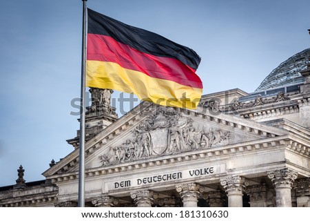 German flag in front of the Reichstag - German Parliament Bundestag Royalty-Free Stock Photo #181310630