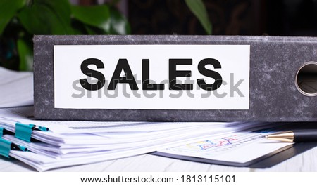 The word SALE is written on the gray paper folder. Marketing concept
