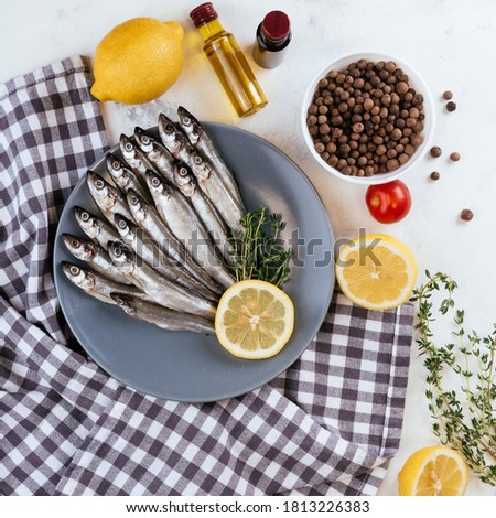 Raw anchovy fish cooking and ingredients.