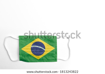 Face mask with printed flag of Brazil, on white background, isolated.
