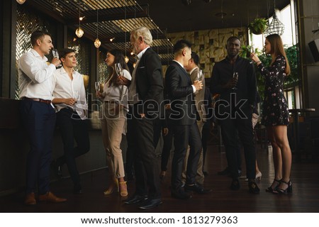 corporate businesspeople having fun and talking together in corporate party in club to celebrate spacial event such as corporate aniversary Royalty-Free Stock Photo #1813279363