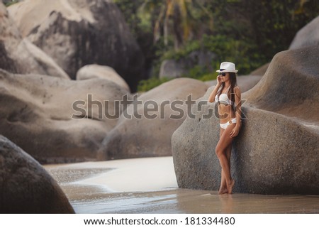Beach woman laughing having fun in summer vacation holidays. Multiracial fashion hipster wearing sunglasses