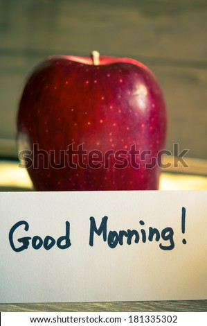 Apple and Good morning note on the wooden table