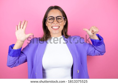Young beautiful business woman over isolated pink background showing and pointing up with fingers number six while smiling confident and happy