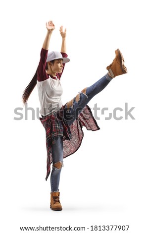 Full length profile shot of a female dancing hip-hop with one leg lifting up isolated on white background