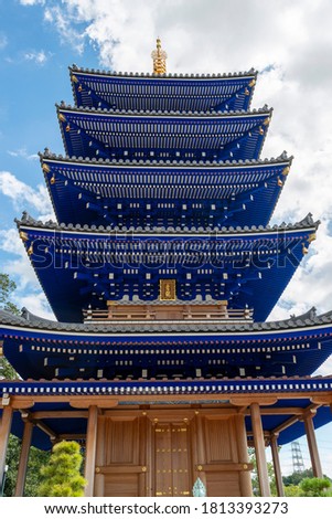 Blue colored five-storied pagoda of Nakayamadera temple in Takarazuka city, Hyogo, Japan.  Translation: two Chinese characters on the plate mean "Blue dragon". 