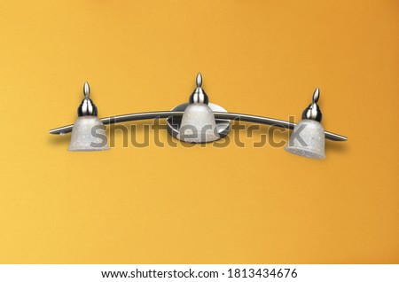 Antique white & metal lamp on yellow wall background