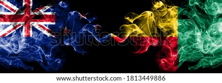 New Zealand vs Benin, Beninese smoky mystic flags placed side by side. Thick colored silky abstract smoke flags
