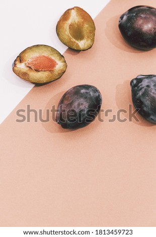 Fashion flat lay composition with fresh plum on brown background. Minimalist details aesthetic. Autumn eco scene concept