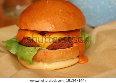 A Delicious burger with cheese and french fries