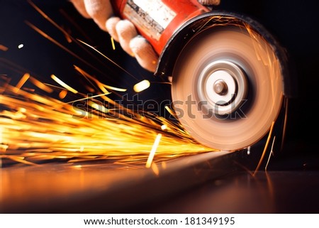 Red hot sparks at grinding steel material. Close up
