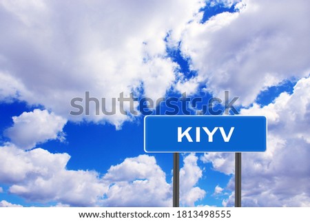 Sign with inscription Kyiv with view of sky. Road sign indicating the settlement. Sign about Kyiv on blue and cloudy sky background