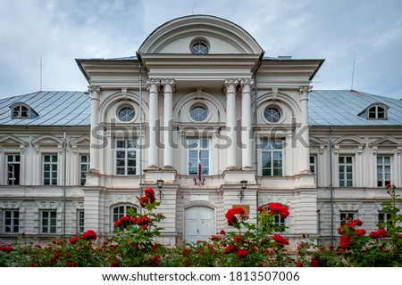 Old manor house with red roses in the foreground. Zalenieki Manor, Green Manor, Latvia.