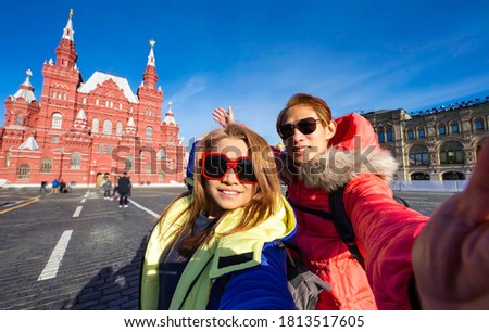 Happy with smile Asian Couple of tourist in love takes selfie portrait in State Historical Museum on Red Square in Moscow, Russia