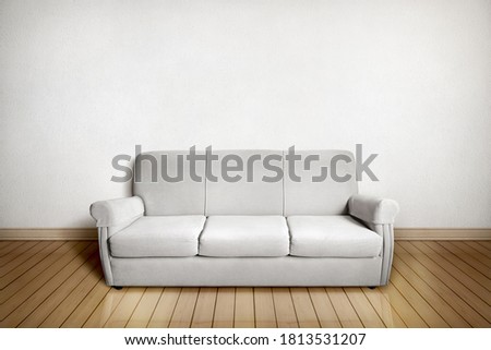 Setting with gray sofa in front of a white wall and light wooden floor. Digital photomontage Royalty-Free Stock Photo #1813531207
