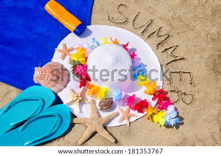 woman's white hat with starfishes and decoration the sandy beach