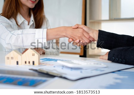 Real estate agents shakehands to congratulate clients on accepting the offer to buy a home at a special price, home lease contract concept. And trading houses