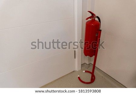 Red Fire Extinguisher on a stand