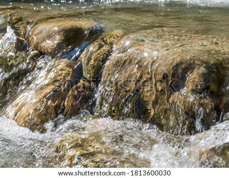 Water stream or creek flowing over the  rocks