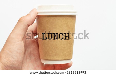 Coffee cup with sign LUNCH, business concept