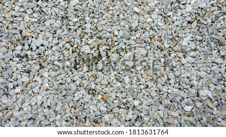 Natural stone crumb. Stone background from natural stone chips: jasper, serpentine, granite. Stone chips for landscaping, garden paths, flower arrangement. Texture of small stones with sharp edges. Royalty-Free Stock Photo #1813631764