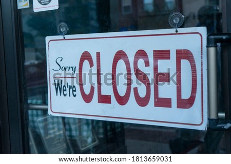 Closed sign at business door due to COVID