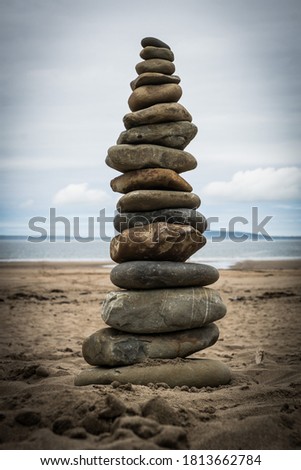 giant stack of stones on sandy beach