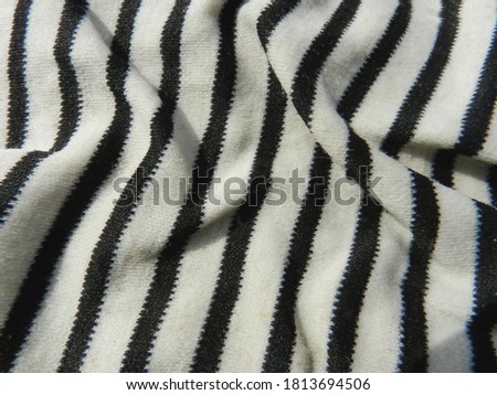 White jersey with black stripes Background. Close-up.