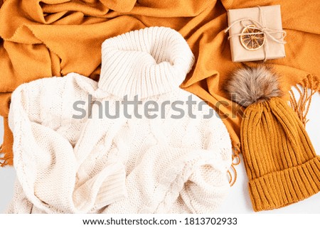 Autumn flat lay composition. Warm comfort sweater, scarf, hat. Autumn, fall, slow living concept. Top view, copy space
