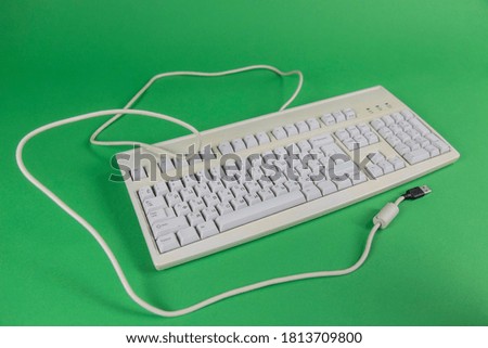 Old white computer keyboard on chroma key