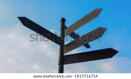 
Direction indicator. Blank directional road signs. Road pointer against the blue sky