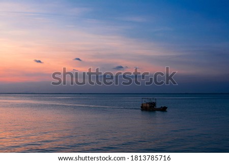 A wandering ship at sunset