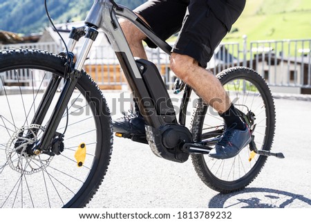 Man Riding E Bike Bicycle In City. Electric Bike In Summer