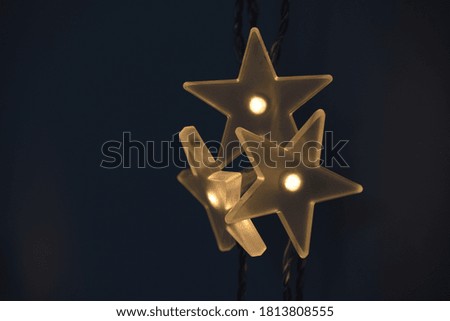 Three glowing stars on dark background