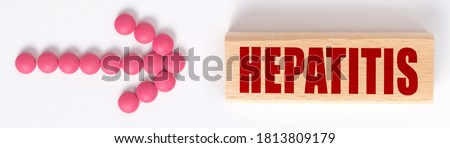 Medicine concept. An arrow of pills points to a sign that says HEPATITIS