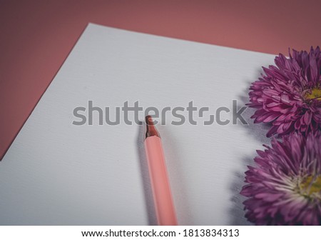 Top view of blank note paper with pen on pink background. Copy space. Back to school and education concept