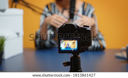 Close up of video blogger recording subscribers present giveaway. Creative content creator social media star influencer expert vlogger recording online internet web podcast gift for audience Royalty-Free Stock Photo #1813861427