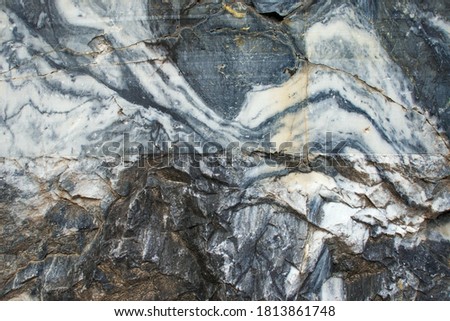 Real faceted marble stone. Background, texture. A marble slab with a characteristic pattern.