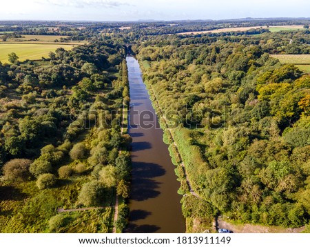 River Weaver is a river, navigable in its lower reaches, running in a curving route anti-clockwise across west Cheshire, northern England. Taken near Hartford, Northwich, Cheshire Royalty-Free Stock Photo #1813911149