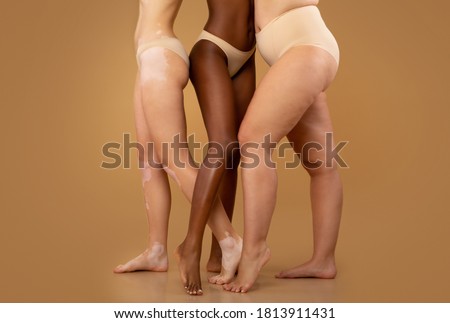 Every Body Is Beautiful. Tree women with different race and body sizes posing in underwear over beige background, cropped image with free space Royalty-Free Stock Photo #1813911431