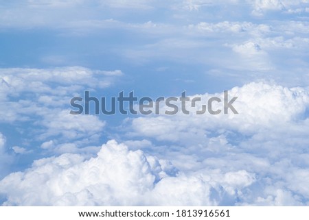 Aerial view of cloudscape seen through airplane window. Space for text.