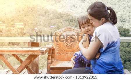 Landscape pictures of Asian mothers and girls embracing each other with warmth and happiness at the outdoor.