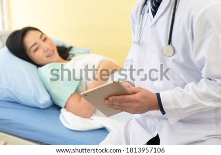 doctor visit asian woman patient who is sick and hospitalized in medicine ward. healthcare and medical concept