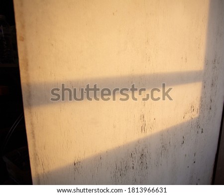 Light shadow on the old white gate