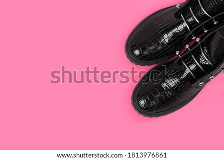 Pair of stylish ankle boots on pink background, top view. Space for text