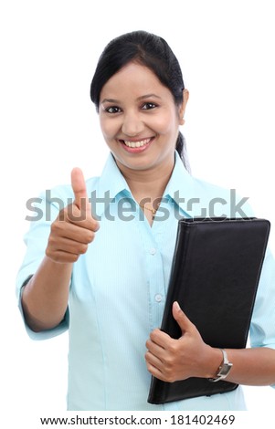 Young business woman with tablet and making thumbs up gesture against white