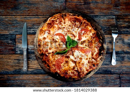 Pepperoni pizza on rustic, vintage style wood background. Top view