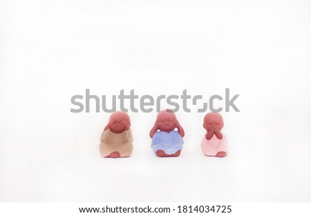 concept of gesture feelings no see, no hear, no speak presented by small cute toy babies on the white background