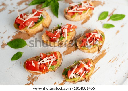 Bruschetta Sandwich served as an appetiser with tomator, avacado, onion and balsamic glaze